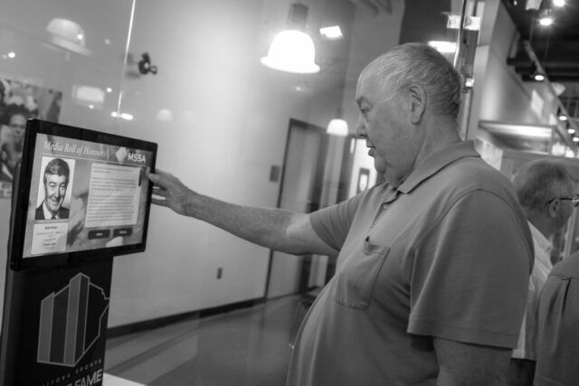 Resby Coutts, who is a Curling Canada Hall-of-Famer and recent Canadian Stick Curling Champion, looking at the digital display.